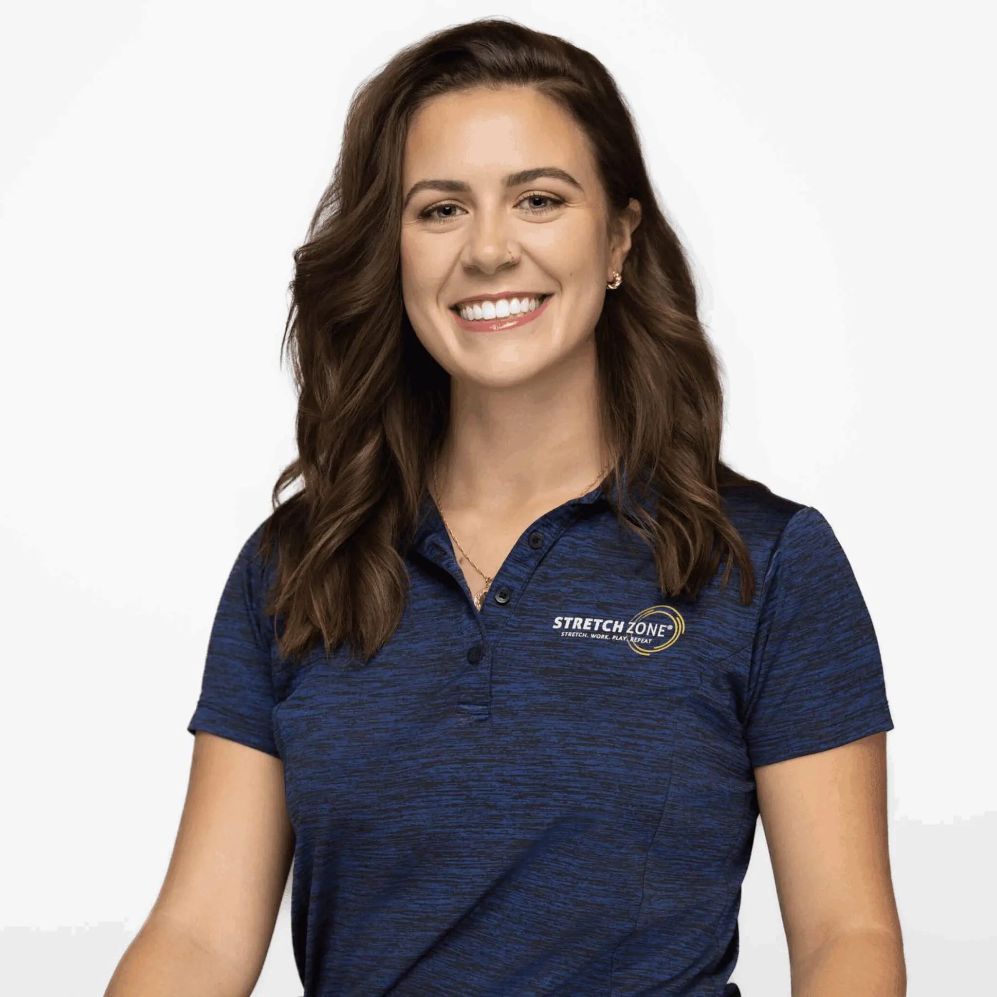 Smiling woman in a navy polo shirt against a white background.