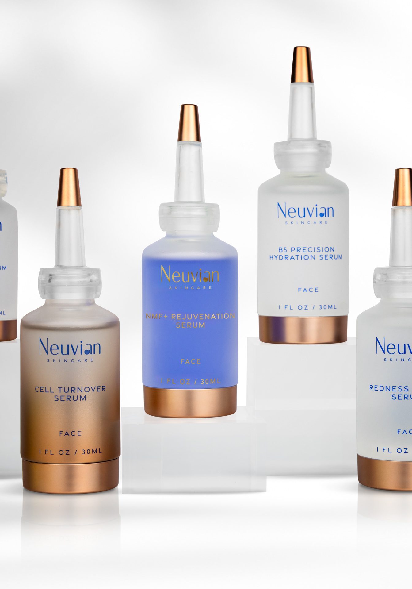 Elegant skincare bottles with gold accents on a white surface.